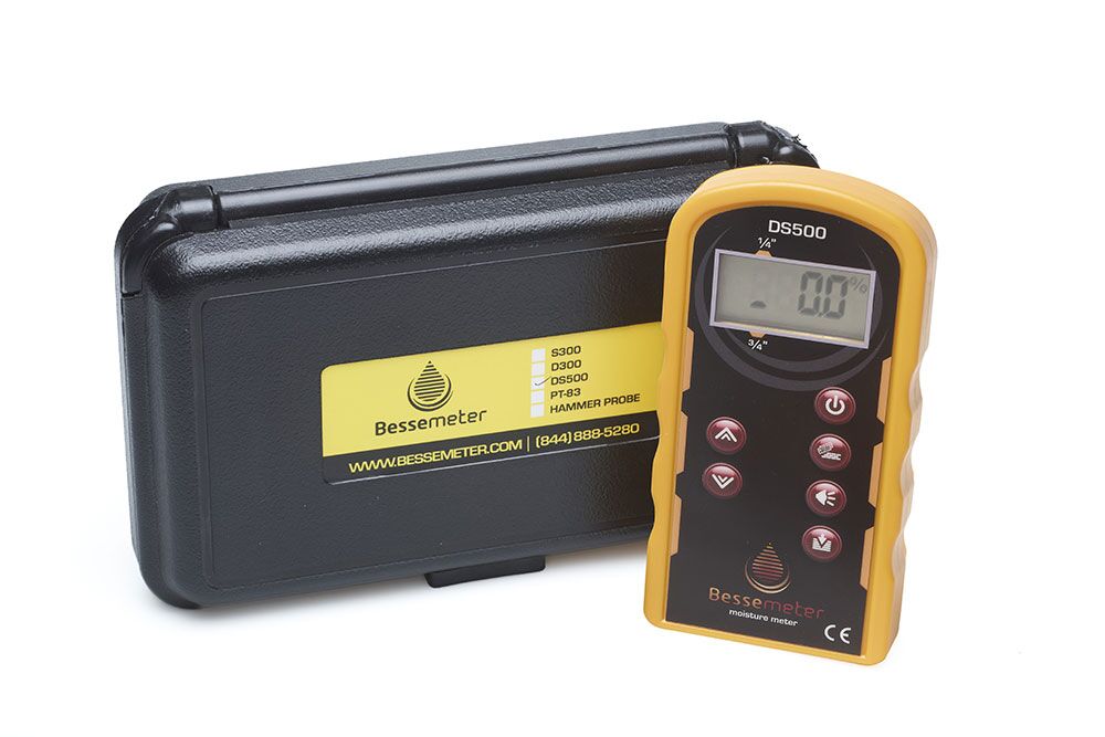 DS500 Dual Scan Pinless Wood Moisture Meter sitting next to the black protective storage case with hardshell for safe carrying